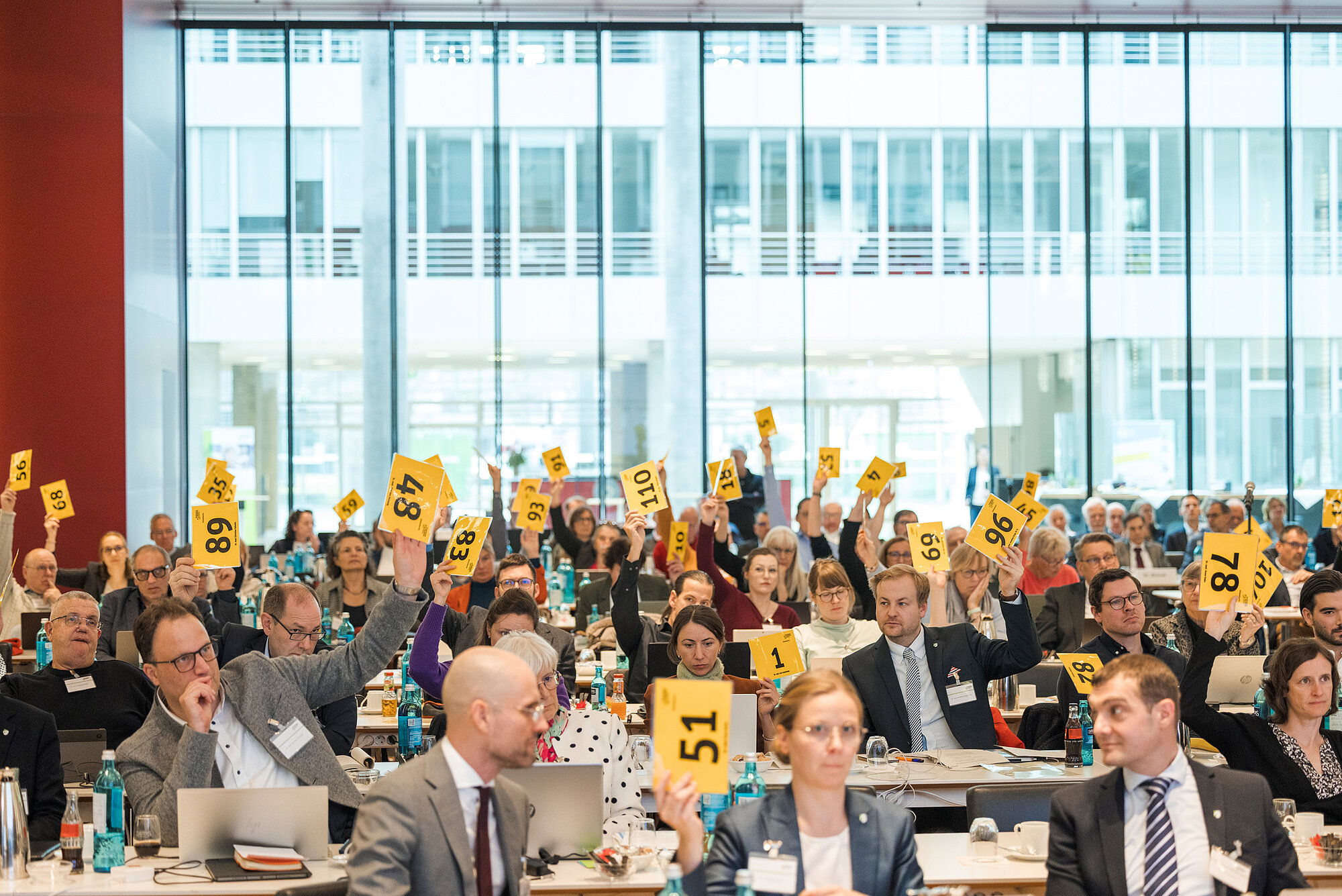Delegierte heben ihre Stimmzettel auf der Kammerversammlung 