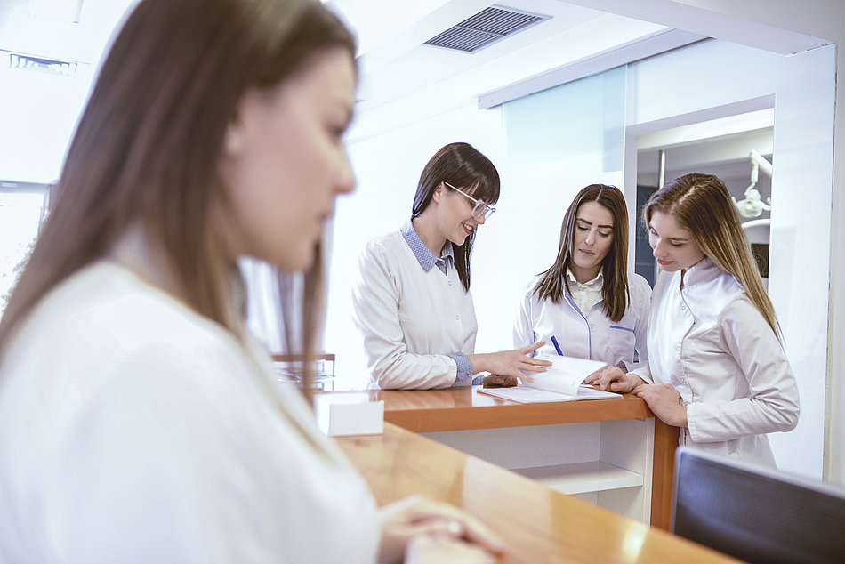 Young Medical Team Have Small Meeting at Clinics Reception